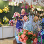 Renee Riggs with flower arrangements